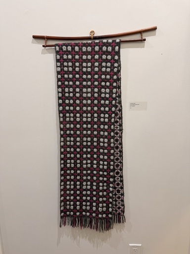 A deflected double weave scarf in red, black, and white.